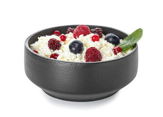 Bowl of cottage cheese with berries on white background