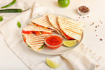 Plate with tasty vegetarian quesadillas and sauce on light background