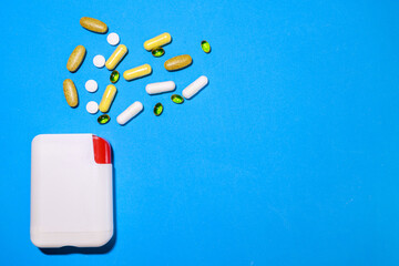 Vitamins and capsules of different shapes were scattered on the table