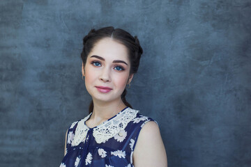 beautiful girl on a blue background, hairstyle beautiful braids