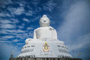 Fototapeta premium Big Buddha monument on the island of Phuket in Thailand.Reinforced concrete structure adorned with white jade marble Suryakanta from Myanmar 