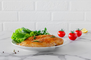 Raw chicken breasts with greens and tomatoes ready for cooking. dietary food