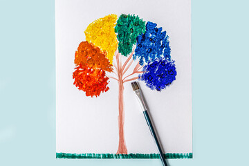 DIY and kids creativity. Painting techniques with thick paint and brush. Children Craft, drawing Rainbow tree.