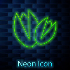 Glowing neon line Pistachio nuts icon isolated on brick wall background. Vector