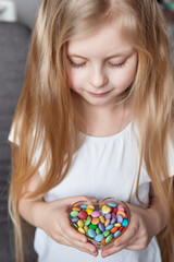 Girl holding a bowl of colorful sweets