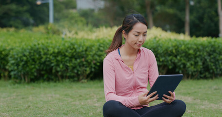 Fototapeta premium Woman use of tablet computer at park