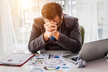Businessman strain on earnings, Stress of businessman with pain expression holding head by hands.