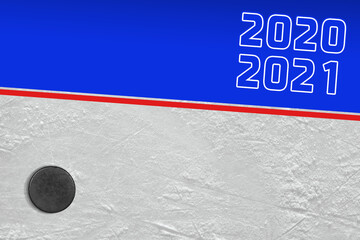 Fragment of the ice rink with a blue line, an inscription and a hockey puck