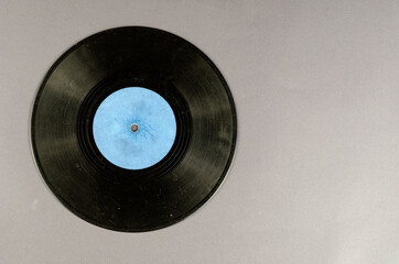Old music record on a gray background.
