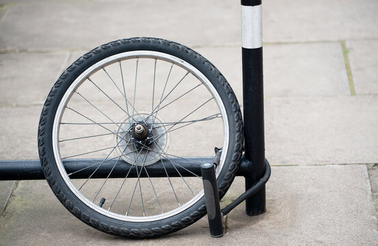 Bicycle Theft - Rear wheel of bicycle with lock attached to bike rack. All that remains after the bicycle was stolen.
