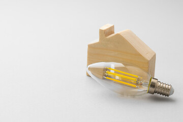 Light bulb on light grey paper background