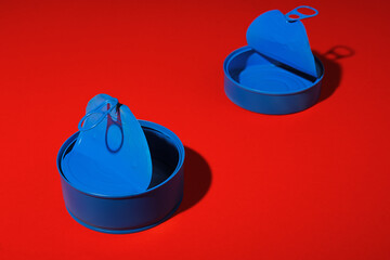 Blue tin can on dark red background