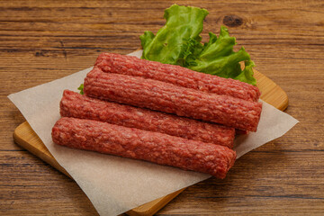 Raw beef sausages with spices