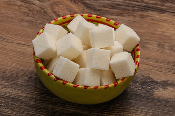 Refined white sugar cubs in the bowl
