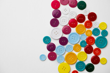 Assortment of colorful buttons on white background