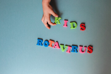 the words kids and rotavirus on a blue background. health concept