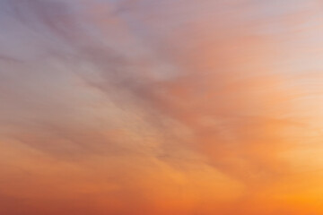 Colorful sunset sky. Beautiful orange natural clouds background in the light of the setting sun