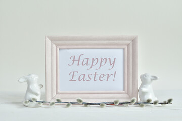 Happy Easter holiday concept, Cute bunny with pussy willow branches with catkins on white background. Text HAPPY EASTER. Springtime. Invitation card design with copy space.