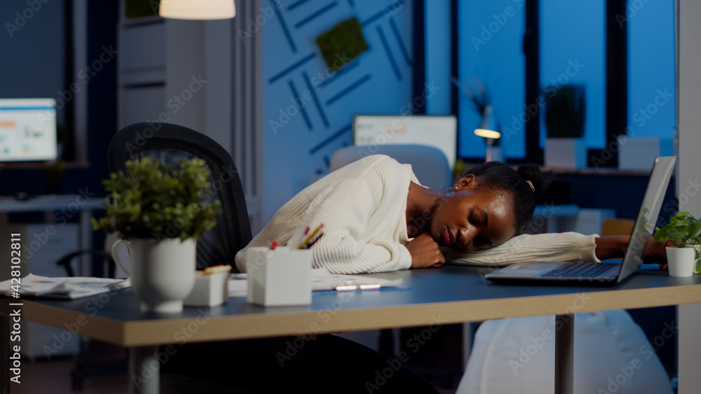 Poster exhausted overload african business woman falling asleep on desk with open laptop monitor while work