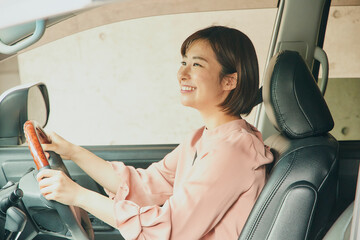 Asian woman driving car portrait