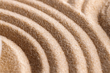 Fototapeta na wymiar Zen pattern in yellow sand, close up.