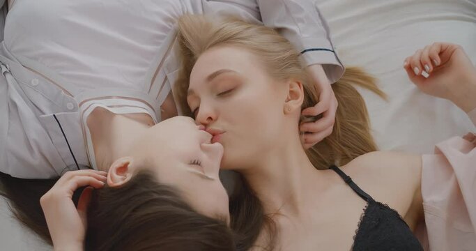 Two lesbians are gently kissing each other in bed Lgbtq Gay Lesbian Bisexual Transgender Lesbian concept Love