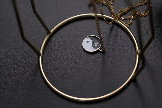 Yin Yang pendant necklace handmade black and white closeup. Selective Focus. High quality photo