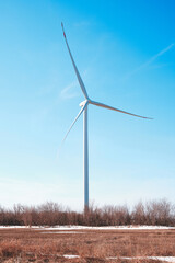 Wind generator in steppe against blue sky, environmentally friendly electricity, wind power plant.