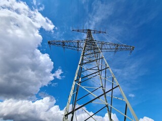 transmission tower in sunshine against blue sky 
