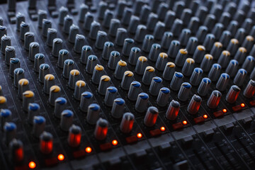 Fototapeta premium Professional audio studio sound mixer console board panel with recording , faders and adjusting knobs,TV equipment.