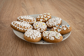 Traditional hungarian gingerbread cookies (hungarian: mézeskalács) in egg form and decorated with Easter patterns on a plate. 