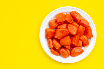 Ripe red Jackfruit on yellow background.