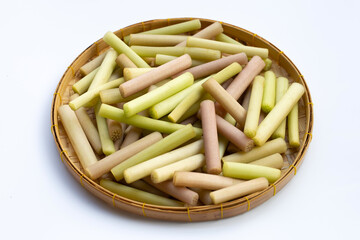 Lotus stems in bamboo basket on white