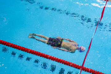 swimmer in the pool, a person swims in the water column, top view, deep dive
