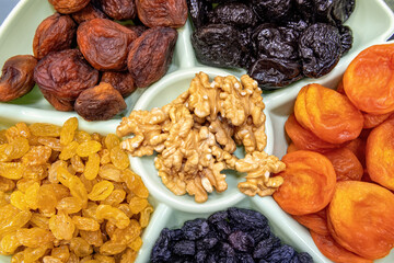 Dried fruits and nuts top view. Dried apricots, raisins, prunes
