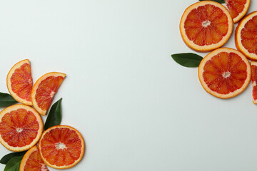 Red orange slices with leaves on white background, space for text