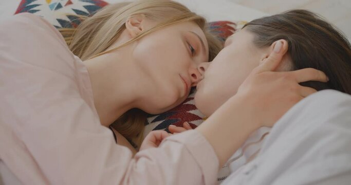 Two lesbians are kissing and hugging in bed Two lesbians are relaxing in bed Lgbtq Gay Lesbian Bisexual Transgender Lesbian concept Love