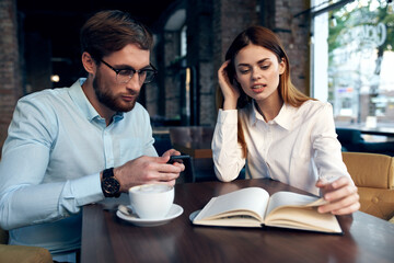 work colleagues in a cafe sit at the breakfast table communication