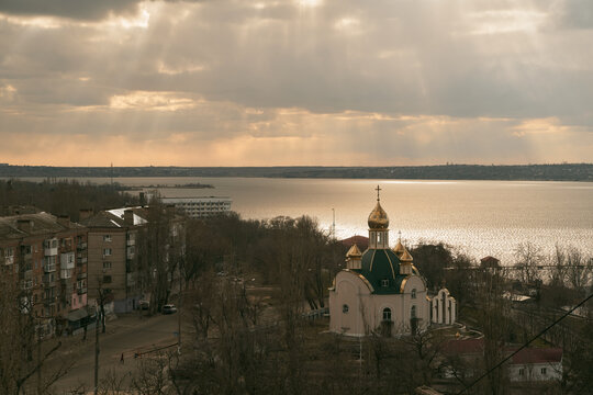 astern Orthodox Church on the river. Sky moving with god rays. Skylapse of the church with golden domes. Dome of the church reflecting floating sky