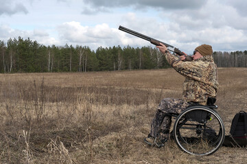 hunter with disability, man with shotgun on the wheelchair