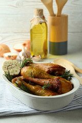 Concept of delicious eating with baking tray with roast chicken drumsticks
