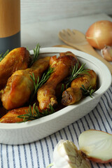 Concept of delicious eating with baking tray with roast chicken drumsticks