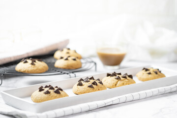 Delicious Whole Wheat Chocolate Chip Cookies set on white cafe table.