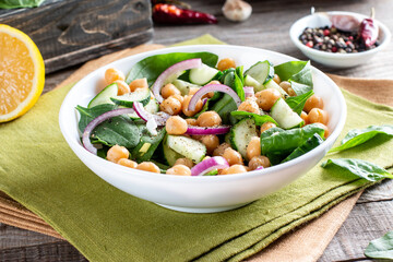 Salad of chickpeas, spinach, cucumbers, onions and greens. Dietary food. Vegan salad.