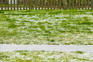 Hailstones falling over green yard. The strong thunderstorms during warm weather in Summer....