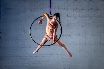 A Young Aerialist Acrobat Woman Working on a Hoop. Circus training.