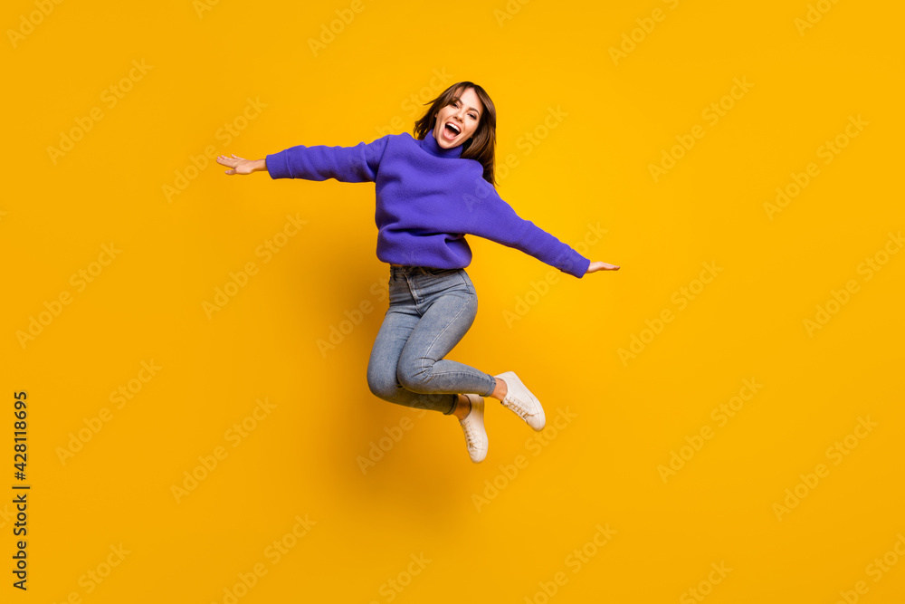 Canvas Prints photo of funny pretty young woman wear purple pullover jumping high arms hands sides isolated yellow