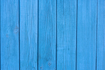 Old blue wooden wall of a house with cracked oil paint. Colorful vintage wood background