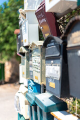 An outdoors shot of a bunch of old mail boxes