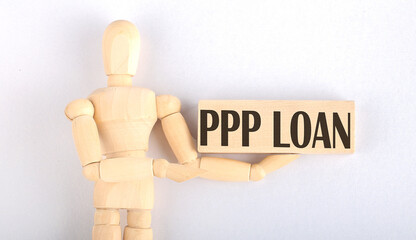 Wooden man shows with a hand to block with text PPP Loan